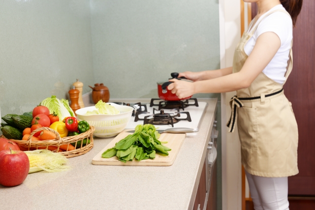 ほうれん草を調理中の女性